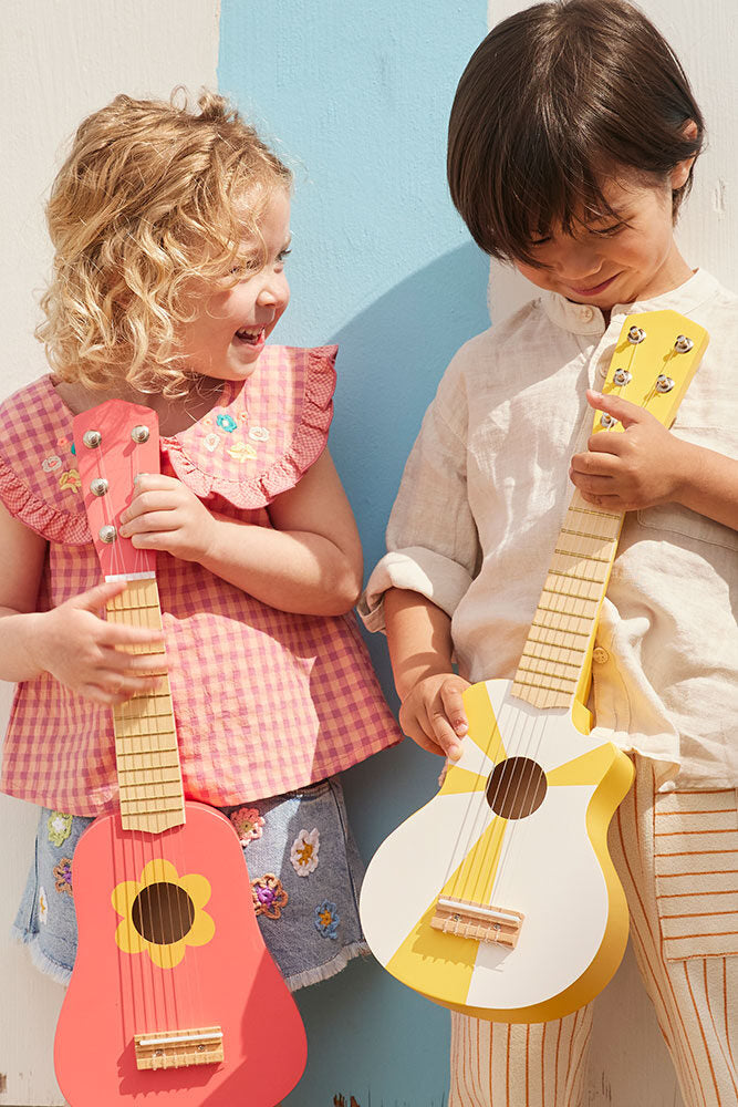 Toy guitar yellow white