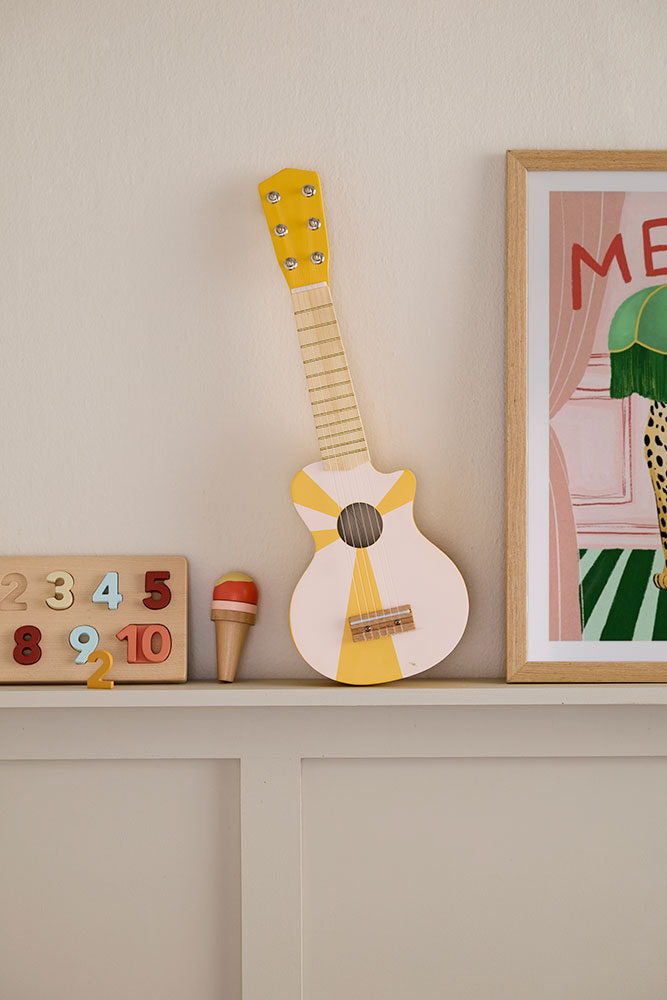 Toy guitar yellow white